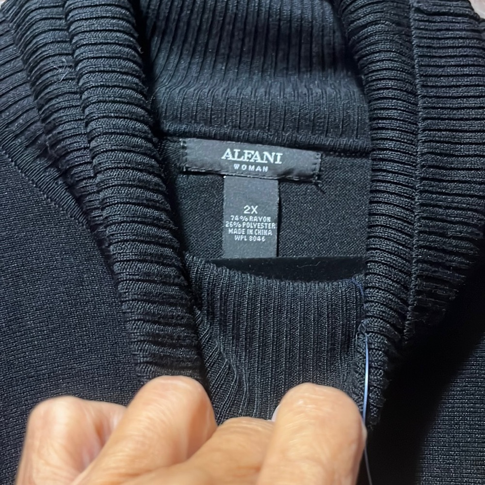 Black poncho sweater with sleeves buttons on the side